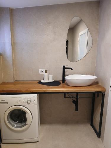 a bathroom with a sink and a washing machine at Bovisa home in Milan
