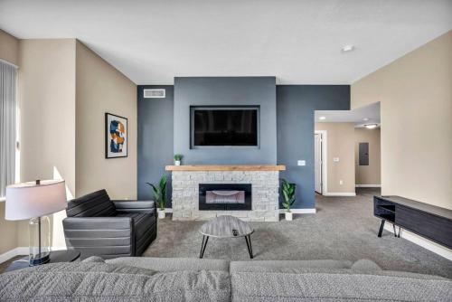 a living room with a couch and a fireplace at 21st Floor Penthouse | Amazing Views of Downtown! in Cleveland
