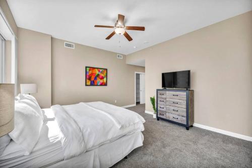 a bedroom with a bed and a flat screen tv at 21st Floor Penthouse | Amazing Views of Downtown! in Cleveland