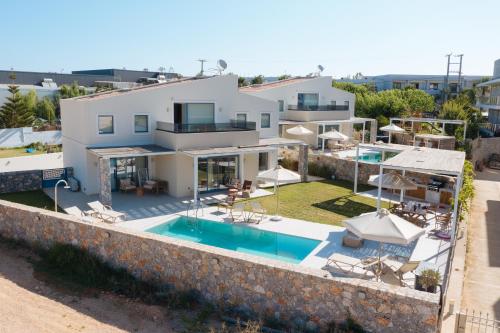an aerial view of a villa with a swimming pool at Pelagia's Loft Villas Haroupi & Rodi with Private Heated Pools, 5 Walking Distance to the Beach in Kavros