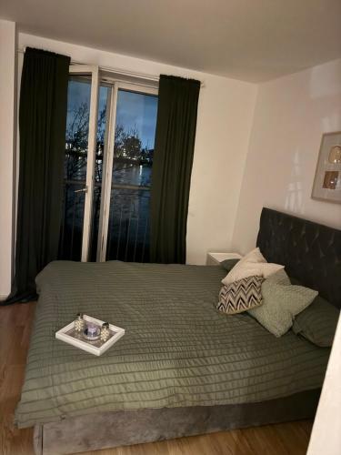 a bedroom with a bed with a tray on it at Canary Wharf Riverside gateway in London