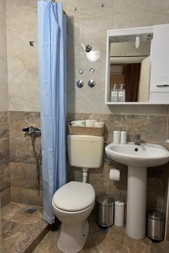 a bathroom with a toilet and a sink at Belmare in Ulcinj