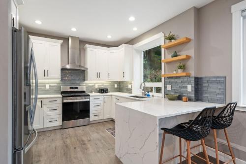 a kitchen with white cabinets and a white counter top at Casa Belli in Bellingham