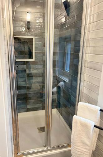 a shower with a glass door in a bathroom at Cantinho D` Alice in Armamar