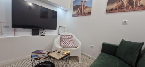 a living room with a couch and a flat screen tv at Cantinho D` Alice in Armamar