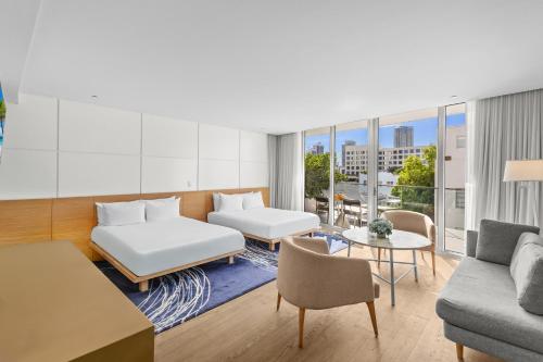 a living room with a couch and a table at Park Central South Beach in Miami Beach