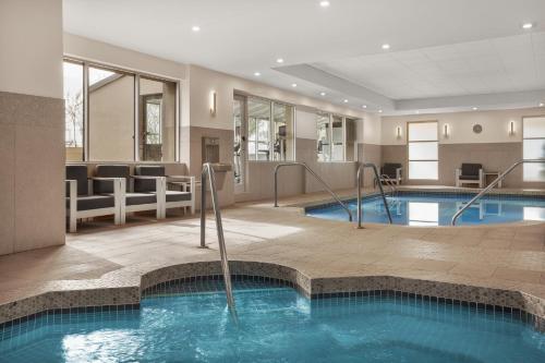 a pool in a hotel room with a swimming pool at Holiday Inn Calgary Airport by IHG in Calgary