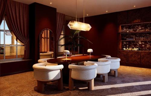 a dining room with a table and white chairs at Bristol Berlin, Vignette Collection by IHG in Berlin
