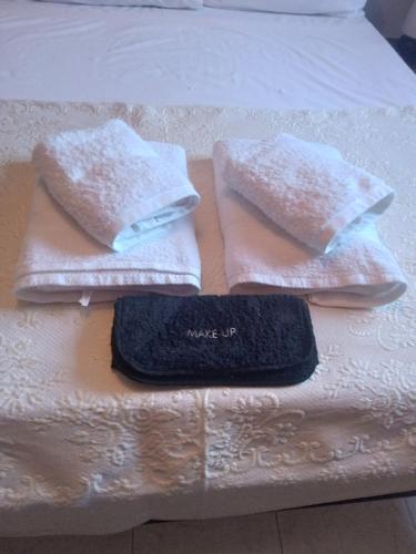 a bed with three towels on top of it at Fabulous Villa in Monemvasia