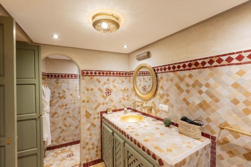 a bathroom with a sink and a mirror at Riad Dar Hamid Hotel & Spa in Marrakesh