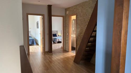 a hallway with a staircase and a room with a bedroom at Casa Rural Caraca in Driebes