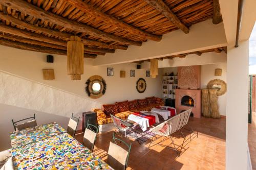 a living room with a couch and a table and chairs at Riad Dar Hamid Hotel & Spa in Marrakesh