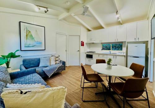 a living room with a blue couch and a table at Kanasta Caravan Park in Rye