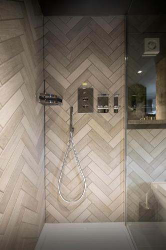 a bathroom with a shower with a glass door at The Bells - Luxury Serviced Apartments in Leeds