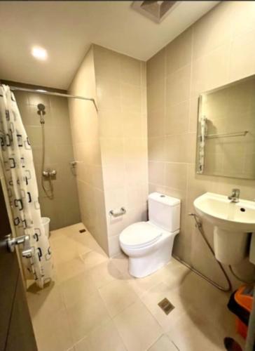 a bathroom with a toilet and a sink at 3ff Megaworld, One Regis in Bacolod