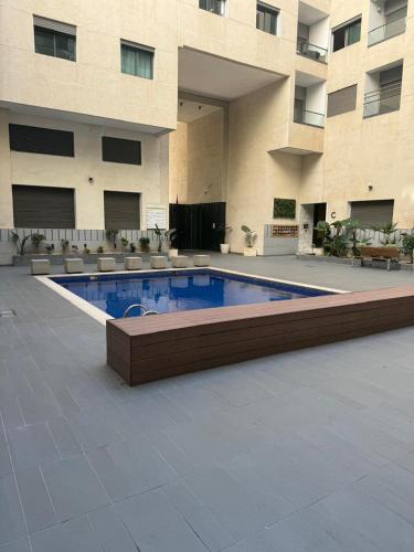 a swimming pool in front of a building at Appartement de lux avec piscine in Mohammedia