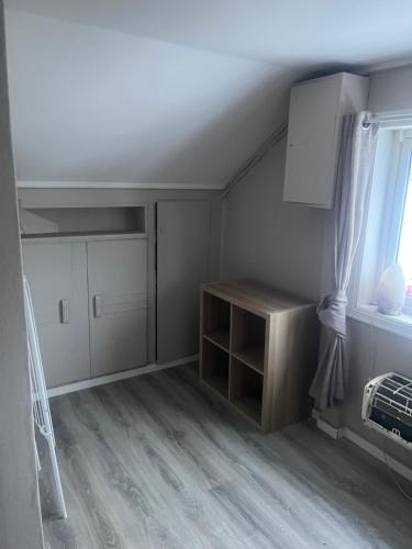 a room with a bed and a cabinet and a window at Hanaborg Appartments in Lorenskog