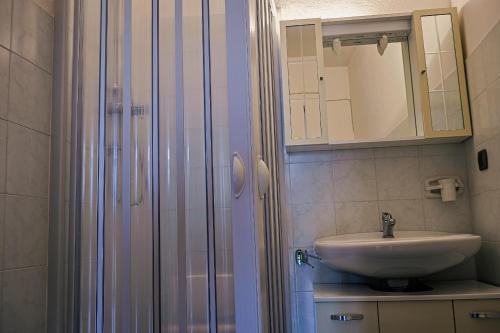 a bathroom with a sink and a shower at La corte del Gavi in Bosio