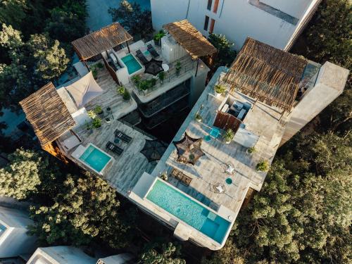 an overhead view of a house with a swimming pool at NAJ Boutique Hotel - Aldea Zama in Tulum