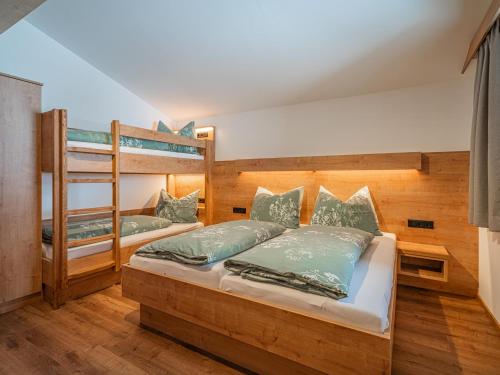 two bunk beds in a room with wooden walls at Glückauf in Krimml