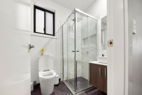 a bathroom with a shower and a toilet and a sink at Gregory Hills Haven Luxe in Gledswood Hills