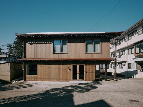 a large wooden house with a roof at mont - Nozawa Onsen Ski Resort in Nozawa Onsen