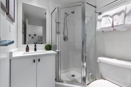 a bathroom with a shower and a toilet and a sink at Sub-Penthouse view condo in Downtown in Vancouver