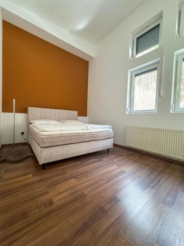 a bedroom with a bed in a room with wooden floors at Komfortresidenz Natur in Weiz