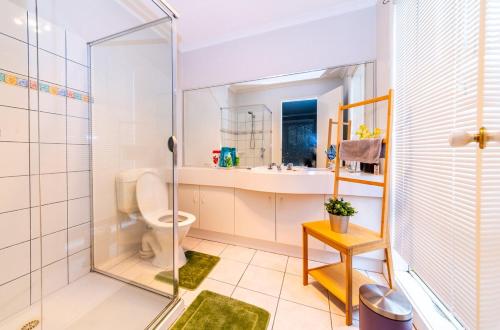 a bathroom with a shower and a toilet at Brightside , Great family home near Airport in Craigieburn