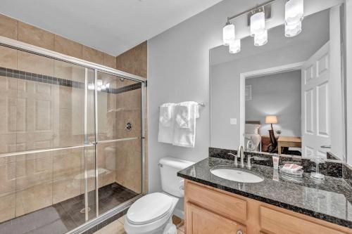 a bathroom with a shower and a toilet and a sink at Central Downtown Condo | Parking & Pool Table in Cleveland
