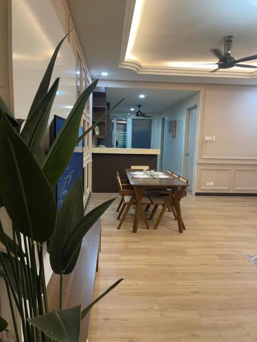 a living room with a table and a potted plant at Hm home 2 in Sepang