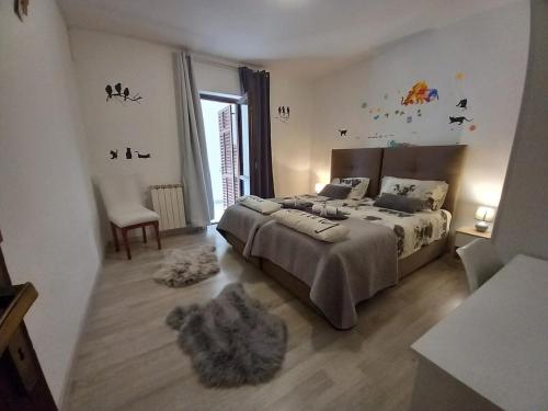 a bedroom with a large bed and a window at Family-friendly apartments with swimming pool Nedescina, Central Istria - Sredisnja Istra - 7455 in Nedeščina
