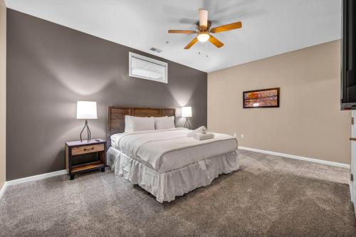 a bedroom with a bed and a ceiling fan at Luxe Downtown Condo • Pool Table & Parking in Cleveland