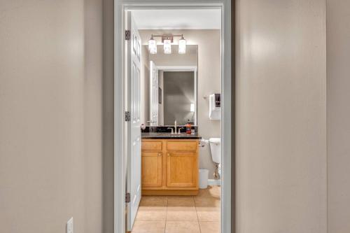 a bathroom with a sink and a mirror at Luxe Downtown Condo • Pool Table & Parking in Cleveland