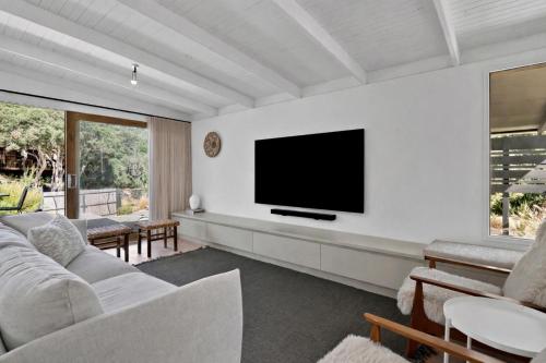 a living room with a television on a wall at Casa Piccolo - Peninsula Hot Springs 5 mins away in Rye