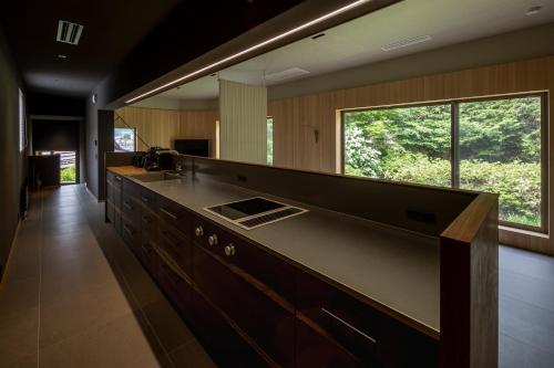 a bathroom with a sink and a large mirror at 左京山SAkyozan in Takayama