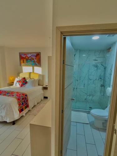 a bedroom with a bed and a shower and a toilet at The Madevelyn in Atitlán in Panajachel