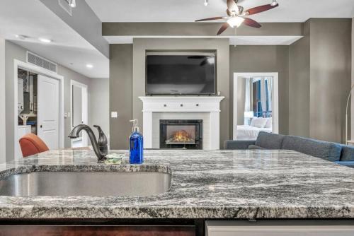 a kitchen with a counter top and a fireplace at LUXE Condo Downtown | Security•Gym•Parking in Cleveland
