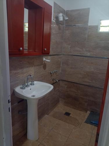 a bathroom with a sink and a shower at Cabañas Arelí in Santa María