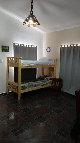 a bedroom with a bunk bed in a room at Cabañas Arelí in Santa María