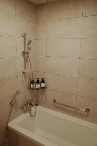 a bathroom with a shower with a tub and a sink at 연봉리 스테이 in Hongcheon