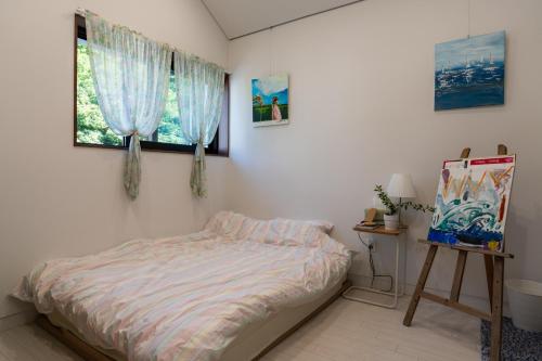 a bedroom with a bed and a window at 연봉리 스테이 in Hongcheon