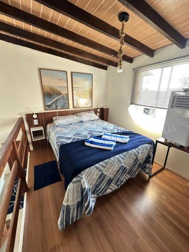 a bedroom with a bed with two towels on it at Casas Temáticas in Tramandaí