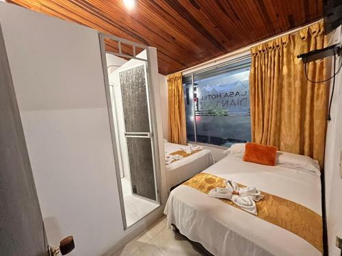 a bedroom with a bed and a window and a tub at Casa Hotel Diana Luz in Villavieja