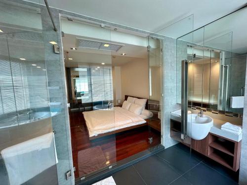 a bathroom with a bed and a sink and a mirror at Fancy Beachfront Condominium in North Pattaya
