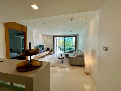 a living room with a couch and a table at Fancy Beachfront Condominium in North Pattaya