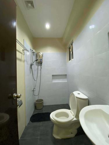 a bathroom with a toilet and a sink at Meg's Resort in Andoon