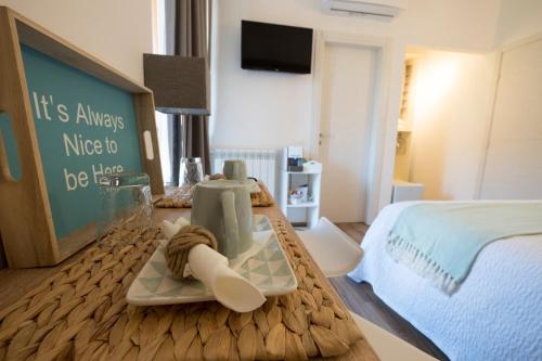 a hotel room with a bed and a table with towels at Suite Simonetta in Sarzana