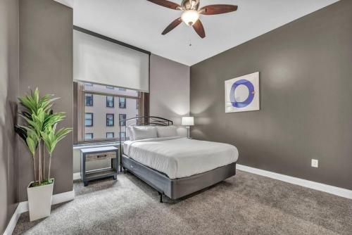 a bedroom with a bed and a ceiling fan at Upscale Downtown Loft | Parking • Gym in Cleveland