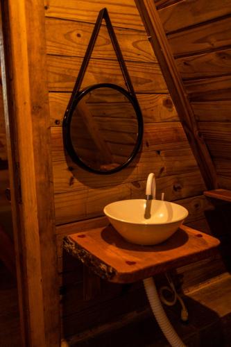 a small bathroom with a sink and a mirror at Cabana Suiça 2 in Guaramiranga